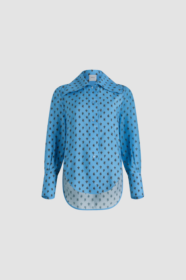 Patou - Fitted shirt in printed sustainable viscose blend - Small Provence Blue - Blue sustainable viscose-blend javanaise shirt. Allover Provence-style motifs. Fitted violin-inspired silhouette. Wide collar. Button front fastening. Buttoned cuffs. Asymmetric front to back hem.