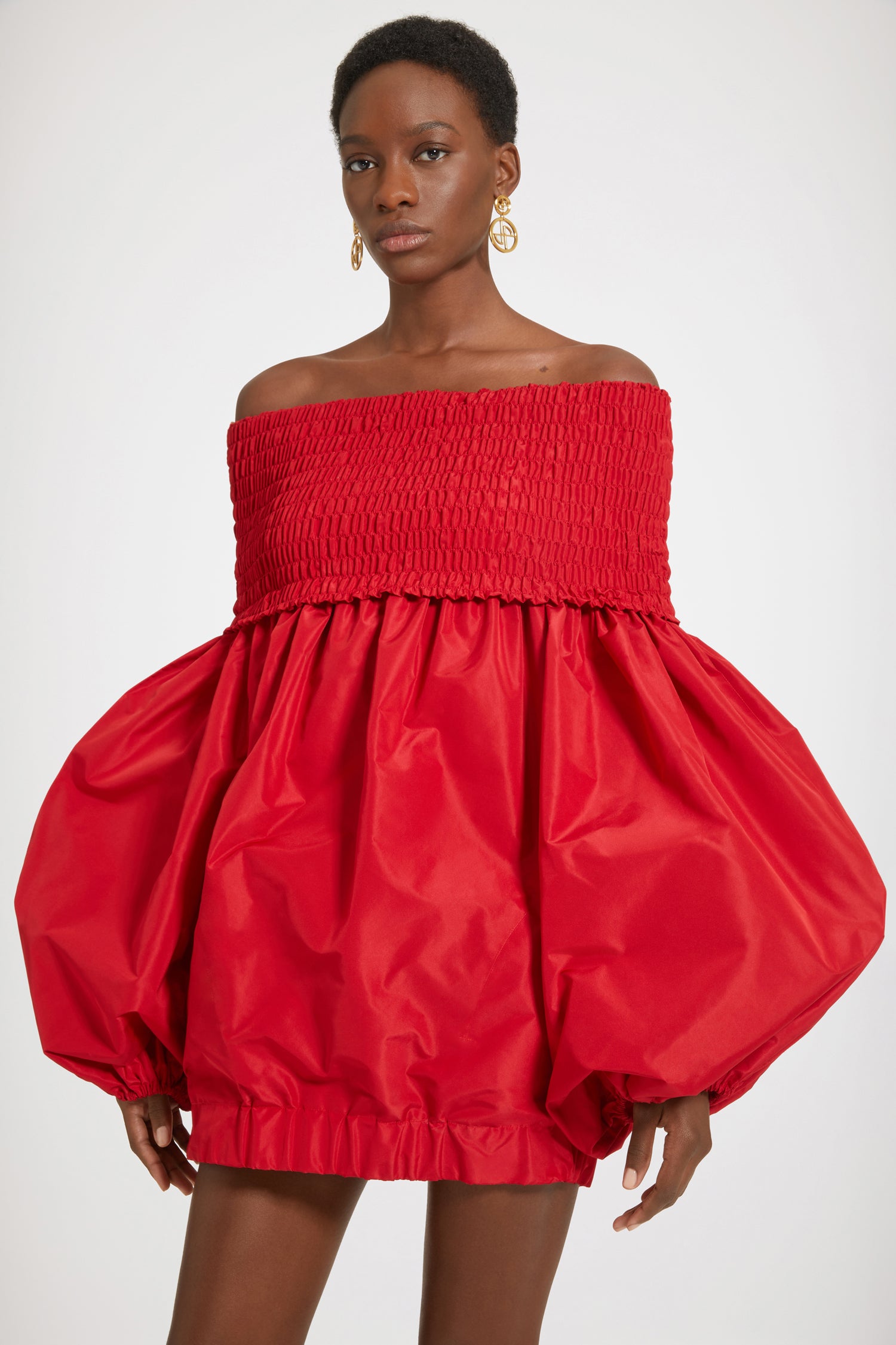 Patou - Off-the-shoulder smock mini dress in eco-friendly faille - Lipstick Red - Off the shoulder, on the radar.Lipstick Red recycled faille dress. Short length. Off-the-shoulder smocked neckline. Volume sleeves with elasticated cuffs. Pockets at the sides. Elasticated bubble hem.This dress is short.