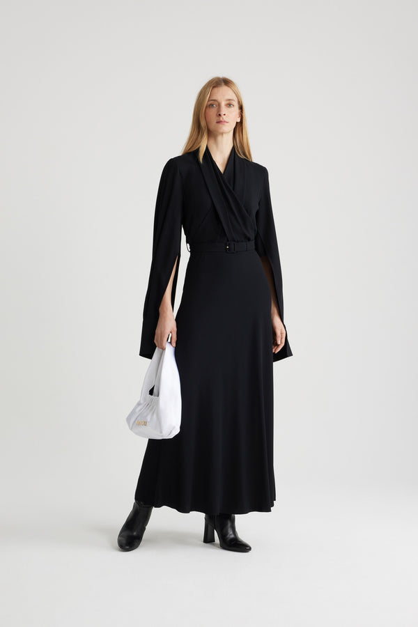 Patou - Wrap bodice maxi dress in sustainable crepe - Black - Black sustainable viscose crepe dress. Maxi length. V neckline. Draped wrap bodice. Puff shoulders. Split sleeves with buttoned cuffs that can be unfastened to create a cape silhouette. Adjustable belt at the waist. This style is fitted at the waist.