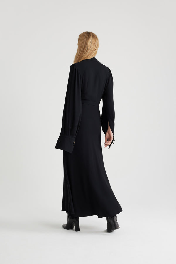 Patou - Wrap bodice maxi dress in sustainable crepe - Black - Black sustainable viscose crepe dress. Maxi length. V neckline. Draped wrap bodice. Puff shoulders. Split sleeves with buttoned cuffs that can be unfastened to create a cape silhouette. Adjustable belt at the waist. This style is fitted at the waist.