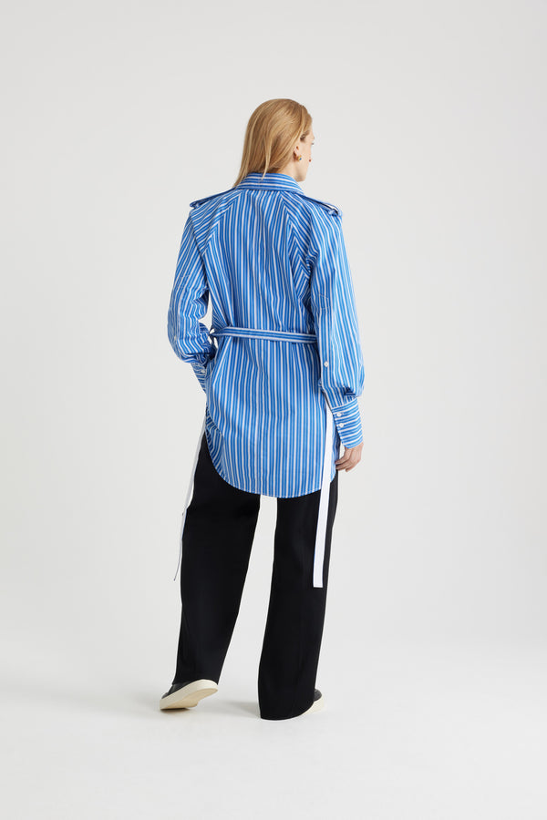 Patou - Mini shirt dress in printed sustainable cotton - Victoria Blue Stripes - Victoria Blue sustainable cotton poplin dress. Striped pattern. Short length. Straight silhouette. Shirt collar. JP-engraved mother-of-pearl buttons. Shoulder tabs. Volume raglan sleeves. Buttoned cuffs. Removable self-tie belt at the waist. Embroidered Patou and JP at the front.