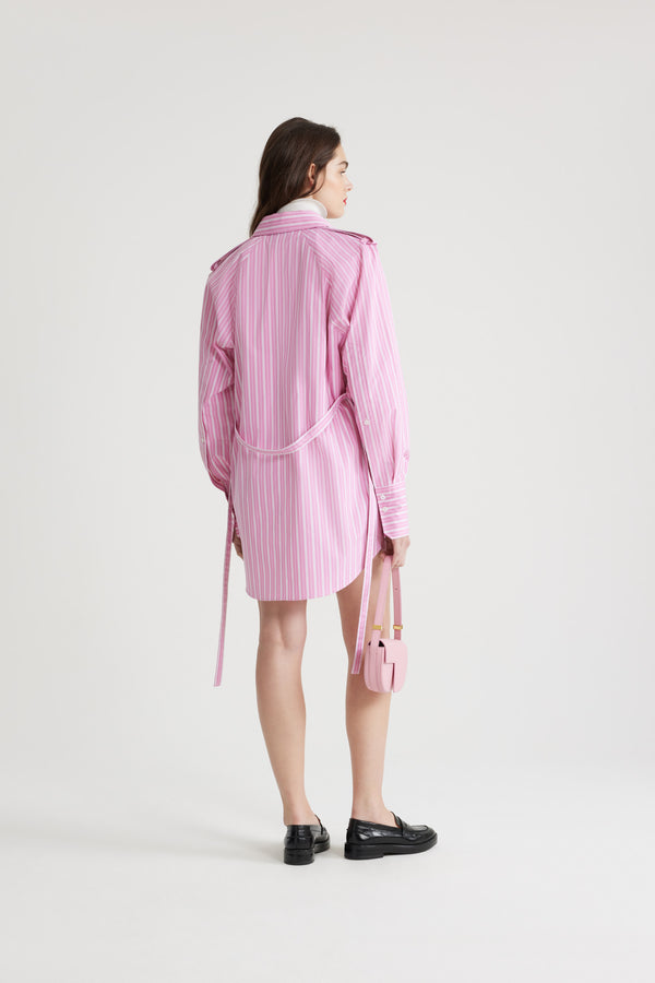 Patou - Mini shirt dress in printed sustainable cotton - Pink Stripes - Pink sustainable cotton poplin dress. Striped pattern. Short length. Straight silhouette. Shirt collar. JP-engraved mother-of-pearl buttons. Shoulder tabs. Volume raglan sleeves. Buttoned cuffs. Removable self-tie belt at the waist. Embroidered Patou and JP at the front.