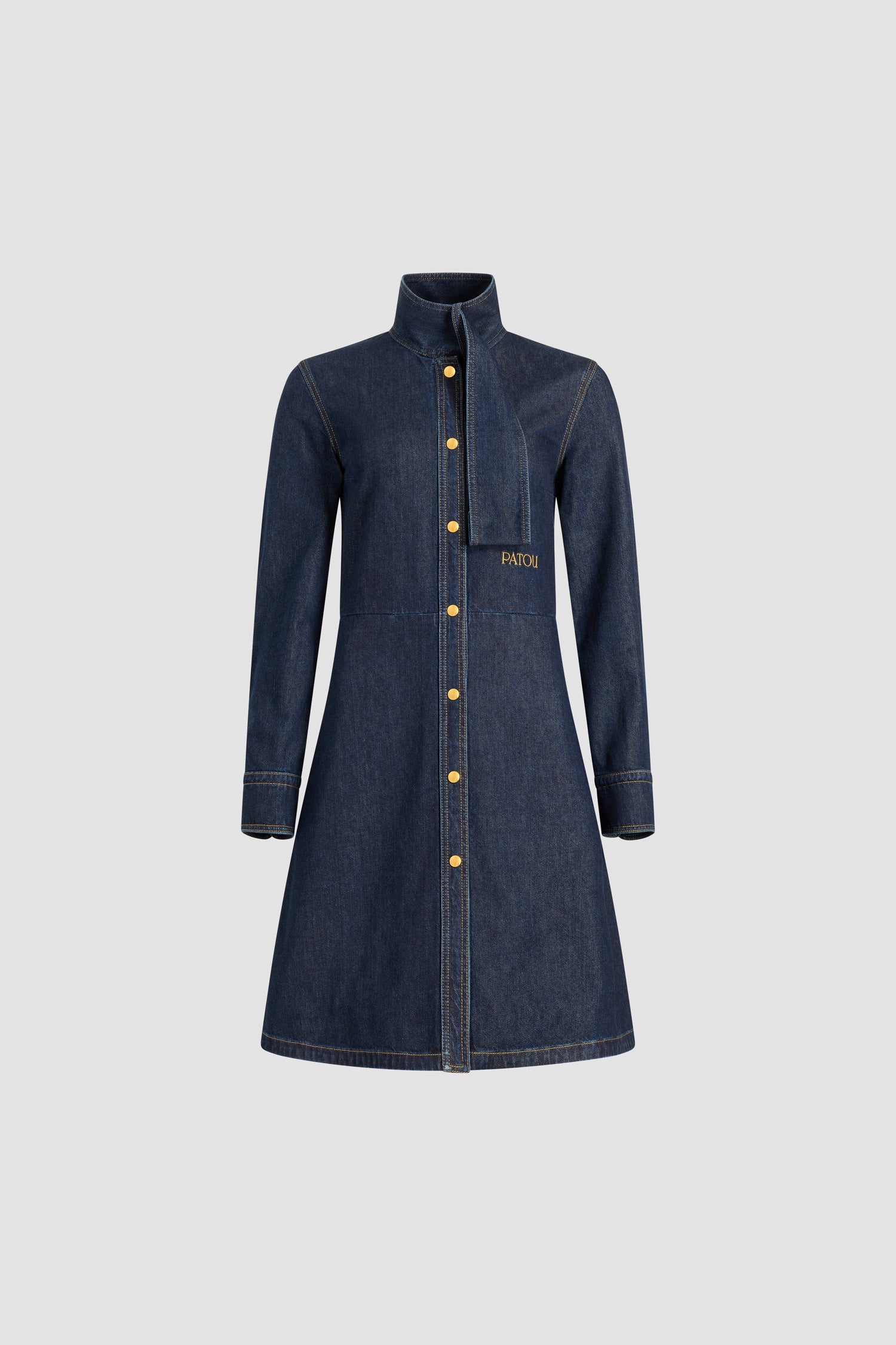 Patou - Scarf collar shirt dress in cotton blend denim - Blue Moon Rodeo - Blue Moon Rodeo cotton blend denim dress. Striped pattern. Knee length. Fit and flare silhouette. Scarf collar with loop at the front. Concealed button front fastening. Patou logo embroidered at the waist. Buttoned cuffs. Pockets at the sides.