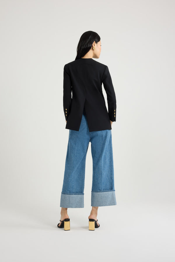 Patou - Collarless double-breasted jacket in tech wool - Black - Black tech wool serge jacket. Double-breasted silhouette. Collarless design. JP-engraved gold-tone buttons at the front and on the cuffs. Slit pocket at the chest, two oversized patch pockets. Patou label on the left sleeve. Fully lined.