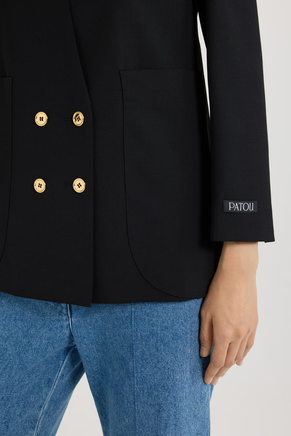 Patou - Collarless double-breasted jacket in tech wool - Black - Black tech wool serge jacket. Double-breasted silhouette. Collarless design. JP-engraved gold-tone buttons at the front and on the cuffs. Slit pocket at the chest, two oversized patch pockets. Patou label on the left sleeve. Fully lined.