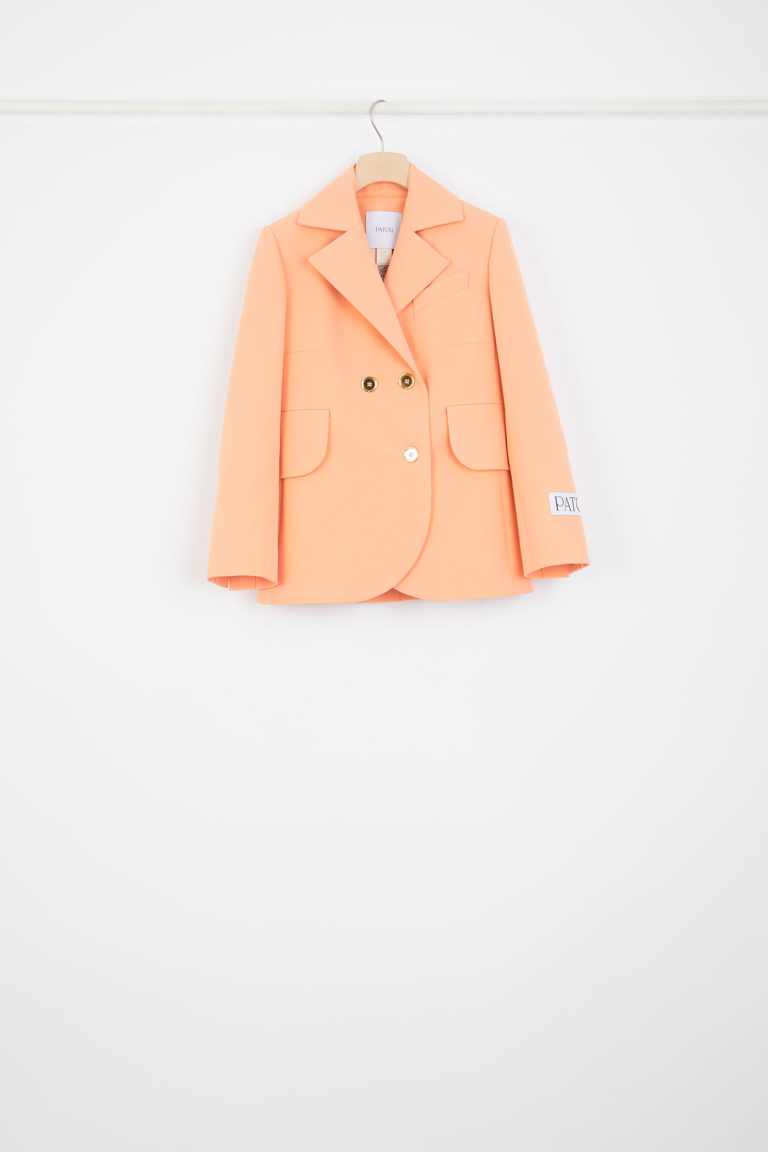Patou - Belted tailored jacket in technical wool - Light orange - One perfect tailored jacket, endless possibilities.Light orange technical wool twill jacket. Double-breasted style. Fitted tailored silhouette. Wide notch lapels. Two gold-tone Patou-engraved buttons. Fabric belt at the waist. Flap pockets. Cropped sleeves. Patou label on the left sleeve.