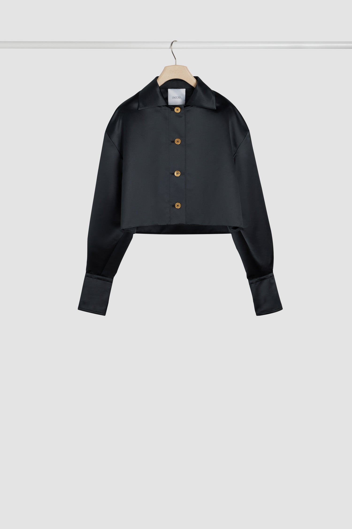Patou - Cropped jacket in satin - Black - Light as a feather, this is the ultimate mid-season layer.Black polyester duchesse satin jacket. Cropped length. Shirt collar. Gold-tone Patou-engraved buttons. Dropped shoulders. Balloon sleeves. Buttoned cuffs.This style is cropped and oversized.