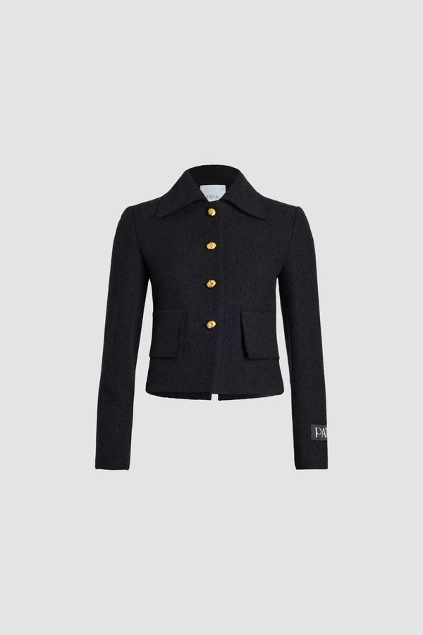 Patou - Iconic short jacket in sustainable wool and organic cotton tweed - Black - Black sustainable wool and organic cotton tweed jacket. Cropped length. Wide collar. Gold-tone Patou-engraved buttons. Patch pockets. Patou label on the left sleeve. Split cuffs. Lined.This style is short and fitted.
