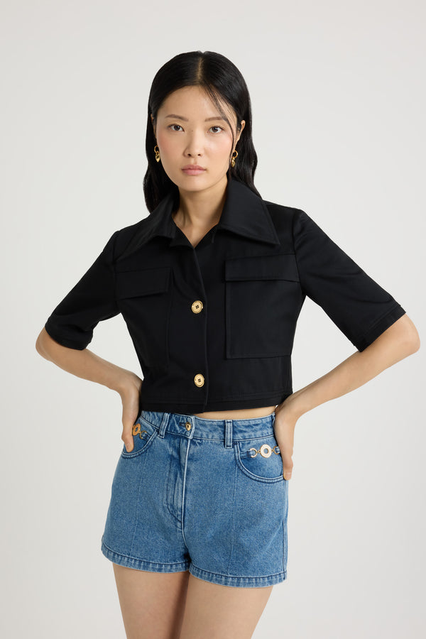 Patou - オーガニックコットンギャバジン ショートスリーブ クロップドジャケット - Black - ブラックカラーのオーガニックコットンギャバジン製ジャケット。クロップド丈。ワイドカラー。ゴールドトーンのJP刻印入りボタン。チェストパッチポケット。五分袖。袖と裾にグログラントリム。