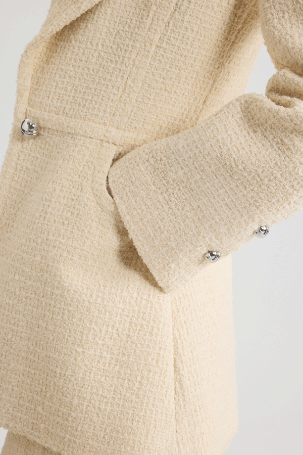 Patou - Longline single-breasted jacket in sustainable wool blend tweed - No Label Snowberry White - Snowberry White sustainable wool blend tweed jacket. Long tailored silhouette. Single-breasted construction. Wide notch lapel. Single silver-tone half-sphere JP monogram button. Buttoned cuffs. Lined