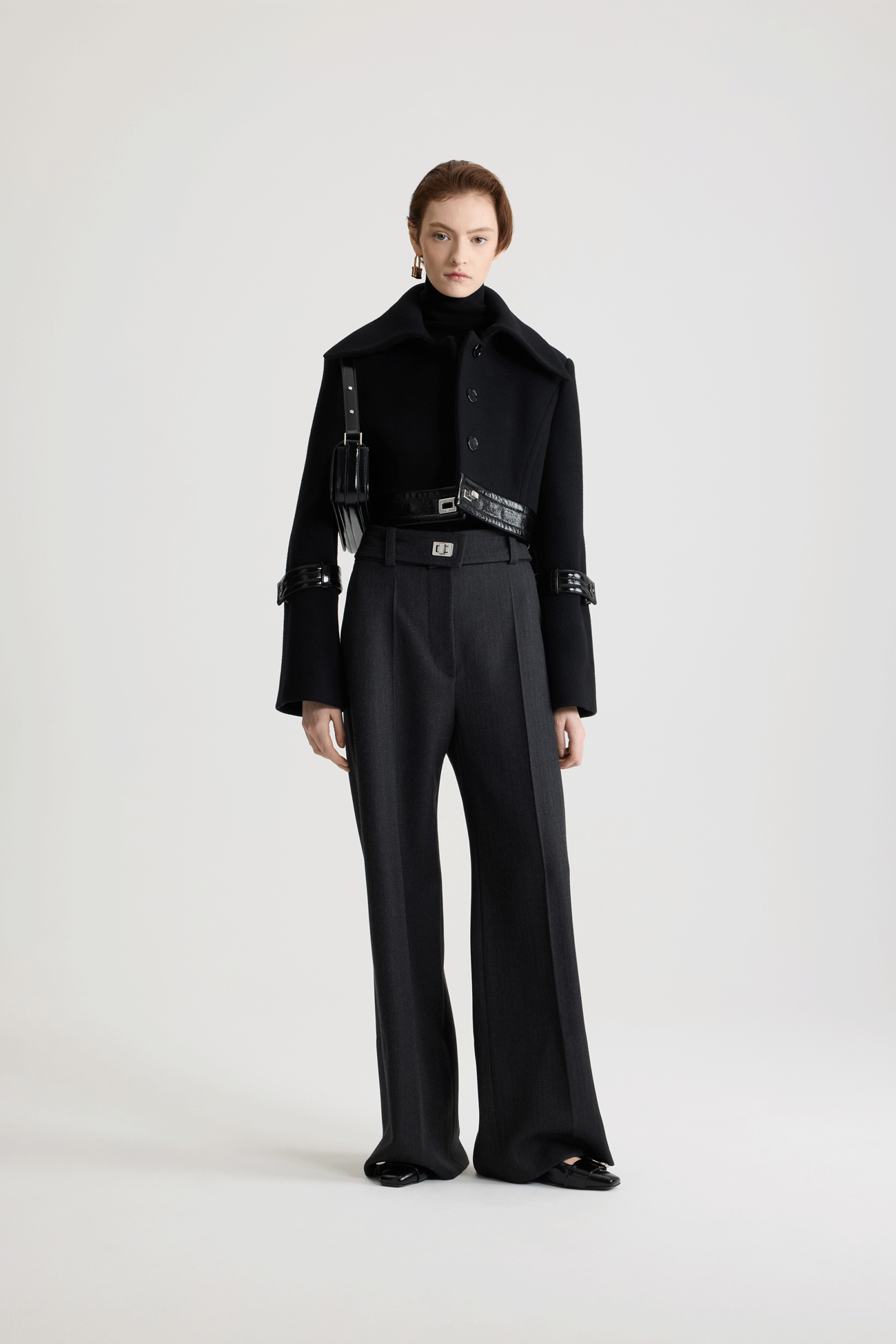 Patou - Cropped lock jacket in sustainable wool blend - No Label Black - Black sustainable wool blend jacket. Cropped silhouette. Single-breasted construction. Wide collar. Concealed button front fastening. Patent leather waistband with silver-tone lock fastening. Patent leather buttoned tabs on the sleeves. Lined