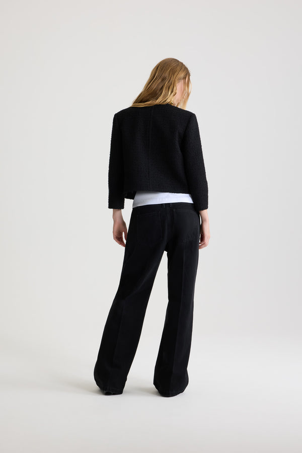 Patou - Short collarless jacket in sustainable wool blend tweed - Black - Black sustainable wool blend tweed jacket. Short length. Single-breasted construction. Collarless design. Button front fastening with half-sphere gold-tone JP monogram buttons. Buttoned patch pockets at the front. Patou logo label on the left sleeve. Lined.