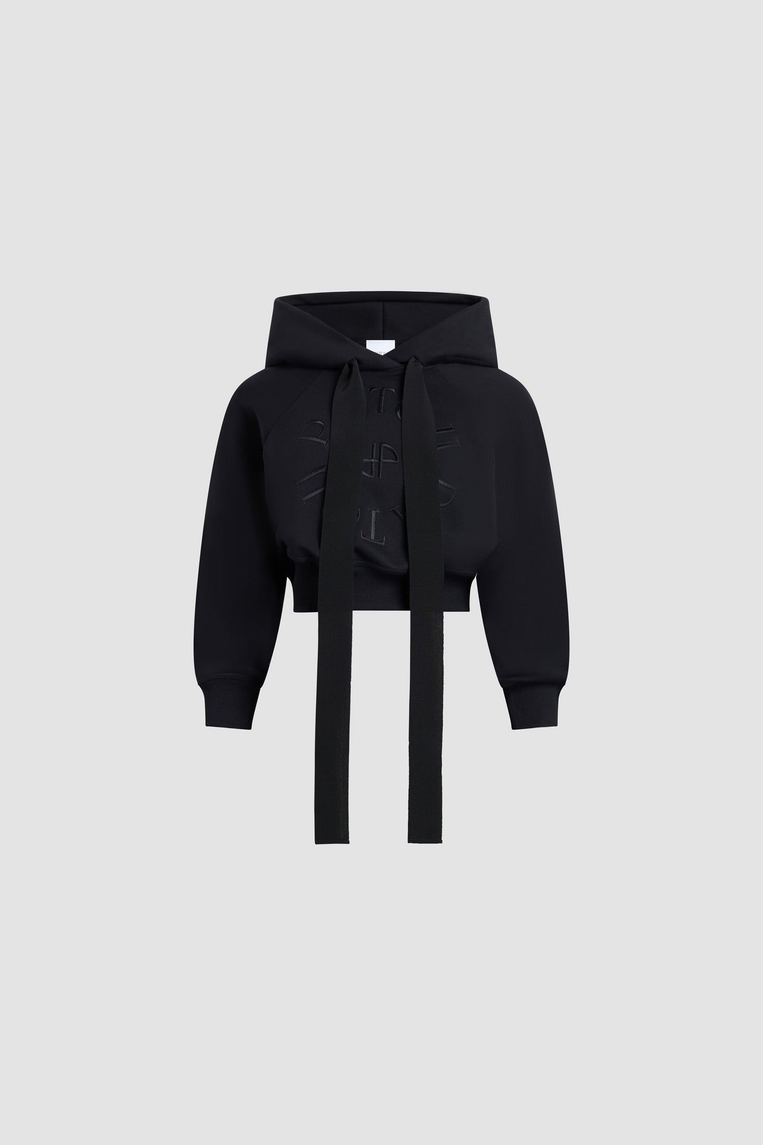 Patou - Medallion logo cropped hoodie in organic cotton - Black - Five letters and a grosgrain bow, a Patou recipe for success. Black organic cotton sweatshirt. Cropped silhouette. Hooded collar with grosgrain drawstring. Patou medallion logo embroidered at the front. Raglan sleeves. Ribbed cuffs and waist.