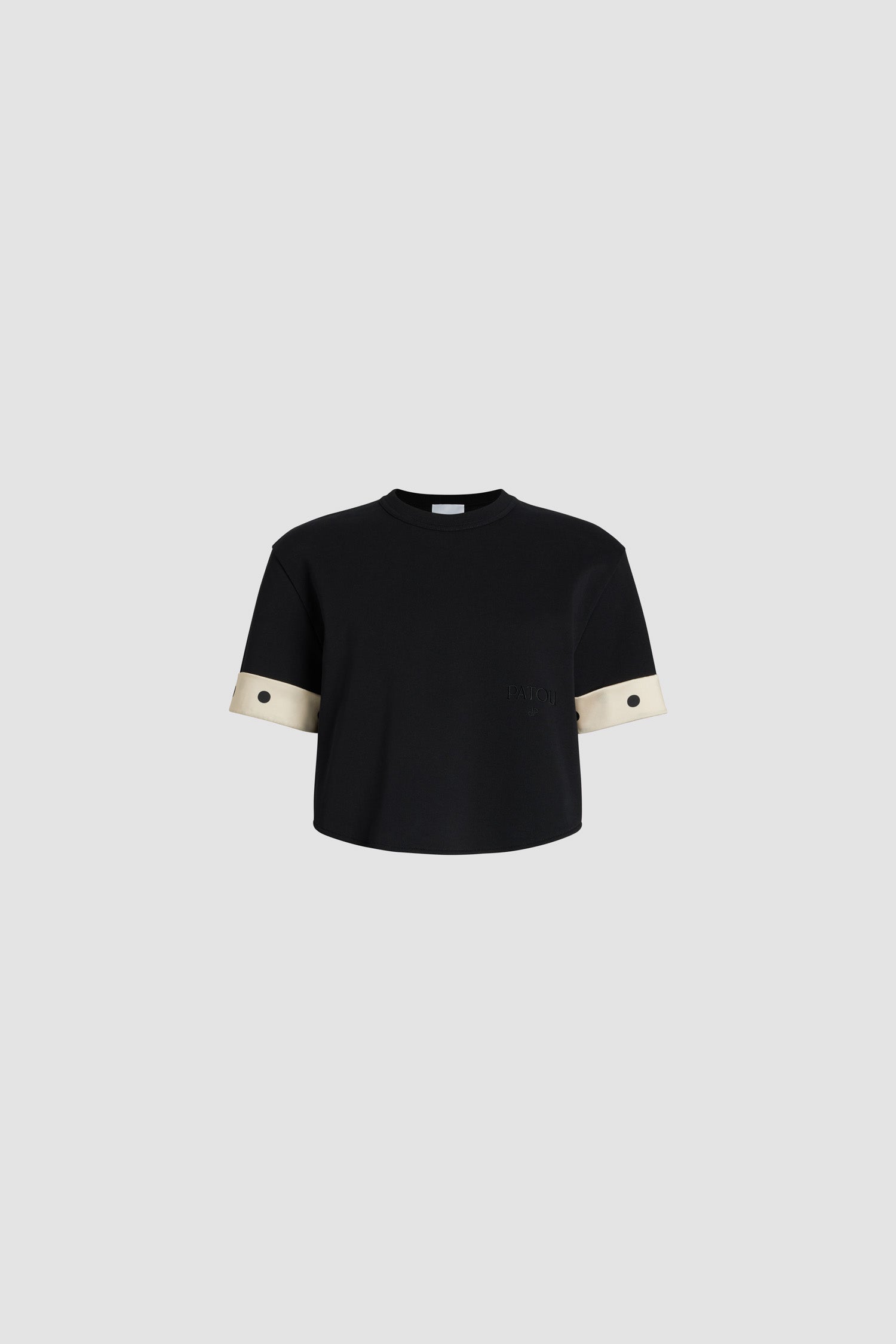 Patou - Silk cuff cropped t-shirt in organic cotton - Black - Black organic cotton t-shirt. Heavyweight jersey. Cropped length, relaxed silhouette. Crewneck. Polka dot silk cuffs. Embroidered Patou and JP at the front.This style is slightly cropped.