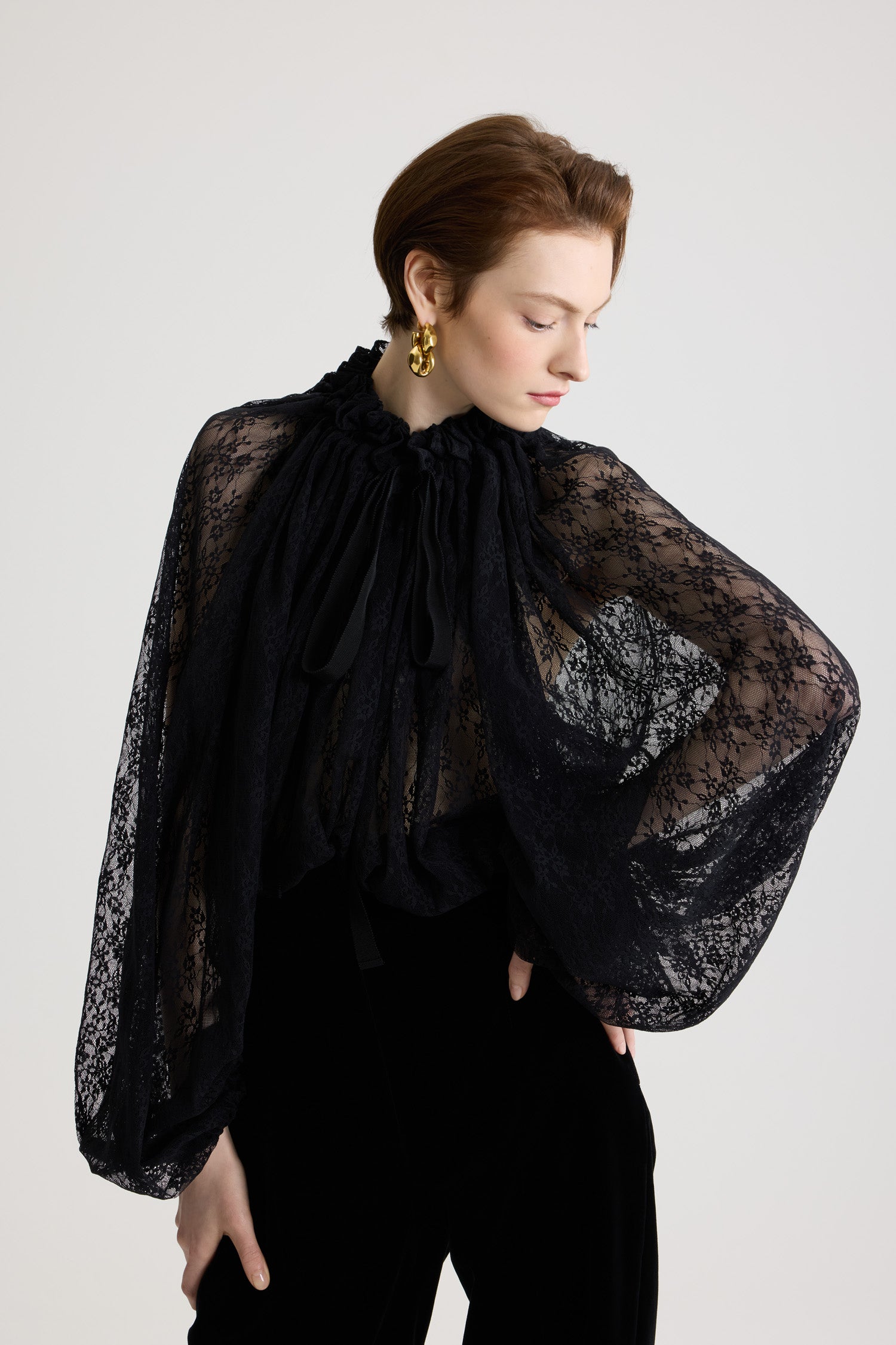 Patou - Iconic drawstring top in lace jersey - Black - Black lace jersey top. Drawstring collar with flounce at the front and long grosgrain ties. Batwing sleeves with elasticated cuffs. Elasticated waist.