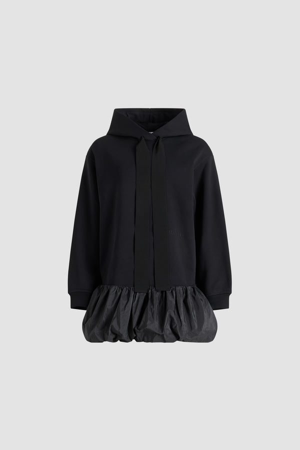 Patou - Ruffle hem hoodie dress in organic cotton and faille - Black - Black organic cotton hoodie. Contrast hem with a polyester faille ruffle. Hooded collar with grosgrain drawstring. Embroidered Patou logo at the front. Ribbed cuffs.