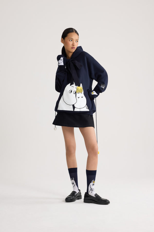 Patou - Patou x Moomin スノークのおじょうさん オーガニックコットンフーディー - Moomin Navy - Patou x Moomin が贈る、心温まるホリデーコレクション。オーガニックコットン100%のフーディーは、リラックス感のある着心地が魅力。ムーミンとスノークのおじょうさんのプリントが、遊び心とノスタルジーを添え、ホリデースタイルをより一層魅力的に演出します。ユニセックスクーペ （男性用はワンサイズ上をお選bi//びください）。