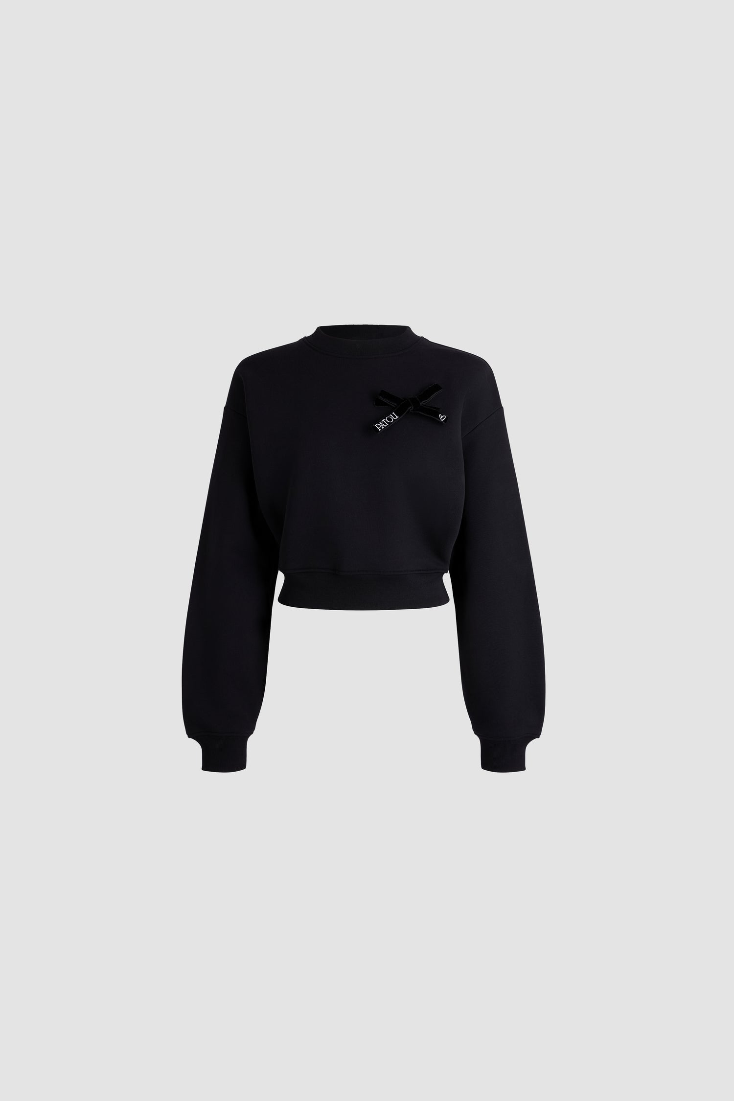 Patou - Cropped bow sweatshirt in organic cotton - Black - Black organic cotton sweatshirt. Round neckline. Bow detail with embroidered logo on the chest. Loose volume. Cropped fit. Ribbed hem and cuffs.