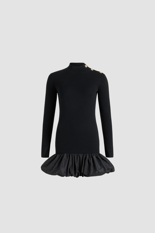 Patou - Ruffle hem ribbed mini dress in wool and faille - Black - Black Merino wool dress. Rib knit. Short length. Fitted silhouette. Mock neck. Gold-tone JP-engraved buttons on the shoulder. Elongated sleeves with split cuffs. Polyester faille ruffle hem.