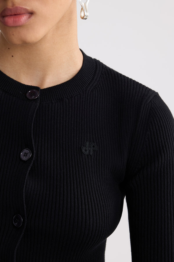 Patou - Cardigan corto a coste in misto cotone eco-responsabile - Black - Cardigan corto a coste nero. Maniche corte. Collo rotondo. Chiusura con bottoni.