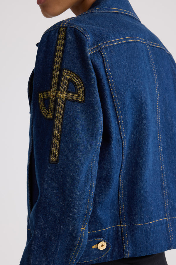 Patou - Embroidered logo denim jacket - Rodeo Blue - Fitted organic blue denim jacket with contrast stitching. Revisited JP logo embroidered on the left sleeve. Engraved gold-coloured buttons down the front, at the waist and cuffs. Two flap chest pockets, two side pockets.Fitted jacket (select one size up for a loose look).