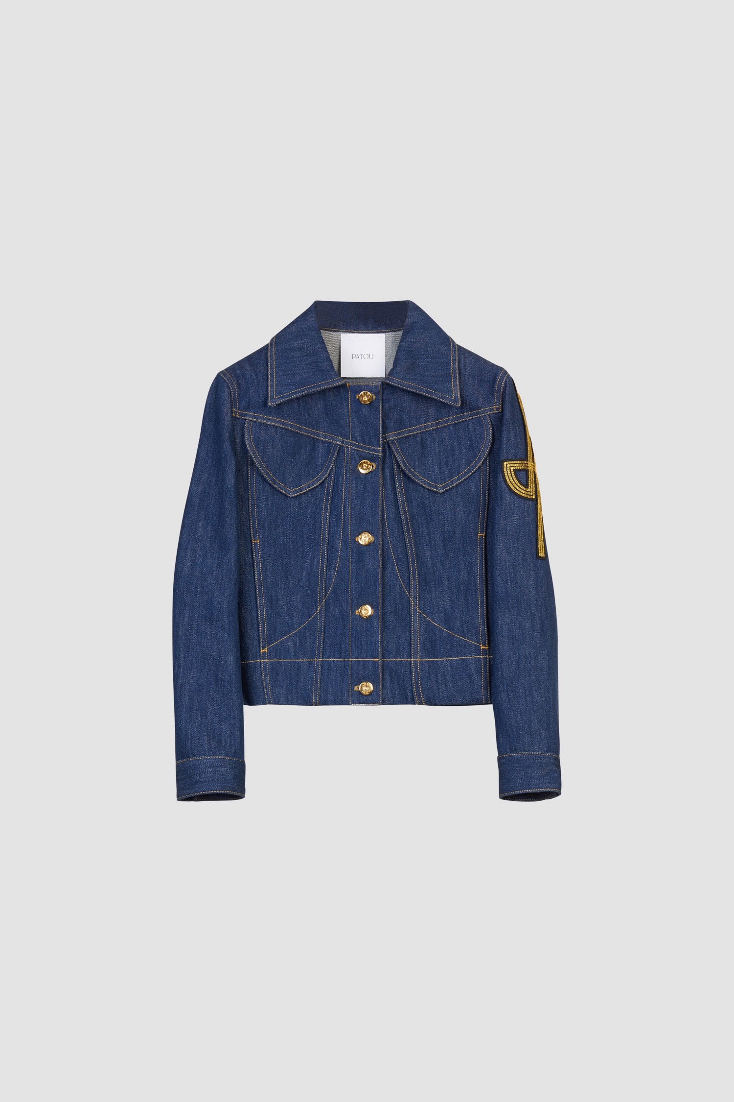 Patou - Embroidered logo denim jacket - Rodeo Blue - Fitted organic blue denim jacket with contrast stitching. Revisited JP logo embroidered on the left sleeve. Engraved gold-coloured buttons down the front, at the waist and cuffs. Two flap chest pockets, two side pockets.Fitted jacket (select one size up for a loose look).