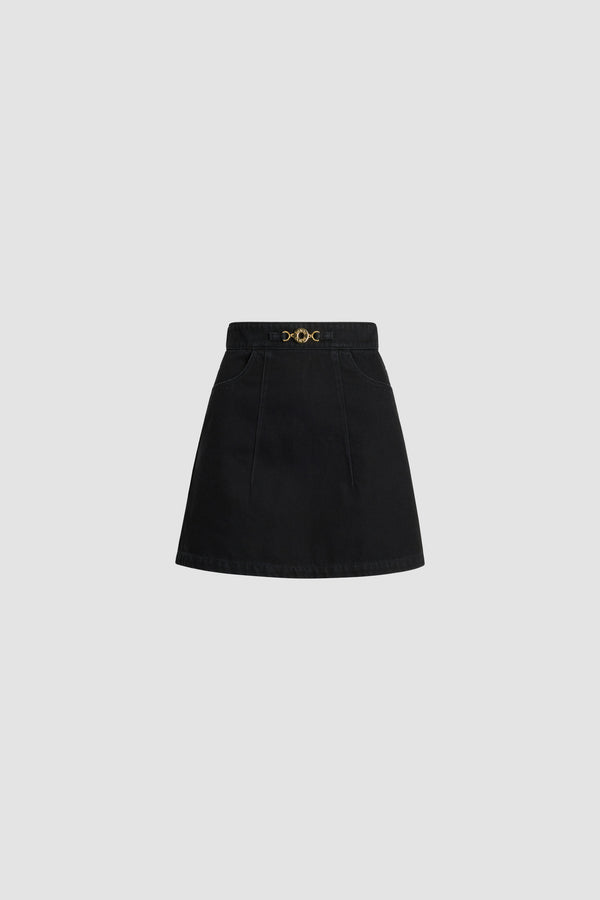 Patou - A-line mini skirt in organic cotton denim - Khol Stone - Khol Stone black organic cotton denim skirt. Short length. A-line construction. Removable gold-tone Patou logo-engraved medallion ornament at the front. Embroidered Patou logo on the waistband. Pockets at the front. Darts at the front and back. Zip fastening at the back. Curved seam at the back.This style is fitted at the waist.