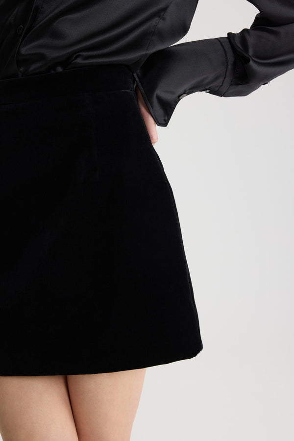 Patou - Iconic mini skirt in organic cotton velvet - Black - Mini jupe noire iconique en velours de coton biologique. Coupe droite.This piece is from the &quot;Evening&quot; Capsule, designed by Guillaume Henry: to immortalize special occasions with style and refinement.