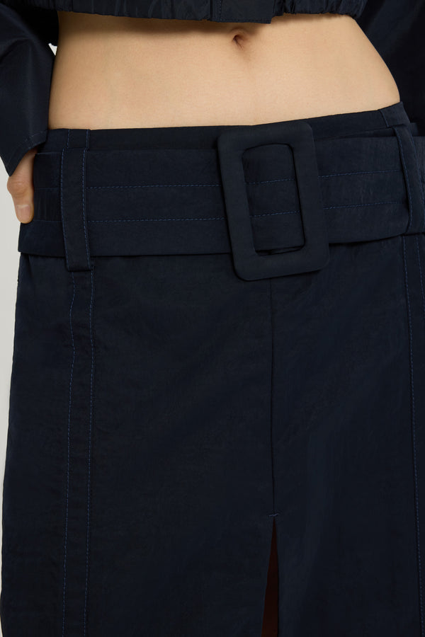 Patou - Belted midi skirt in lightweight recycled nylon - Navy Black - Navy Black lightweight recycled nylon skirt. Midi length. Low waist. Removable wide fabric belt. High slit at the front. Zip fastening at the back. Lined.