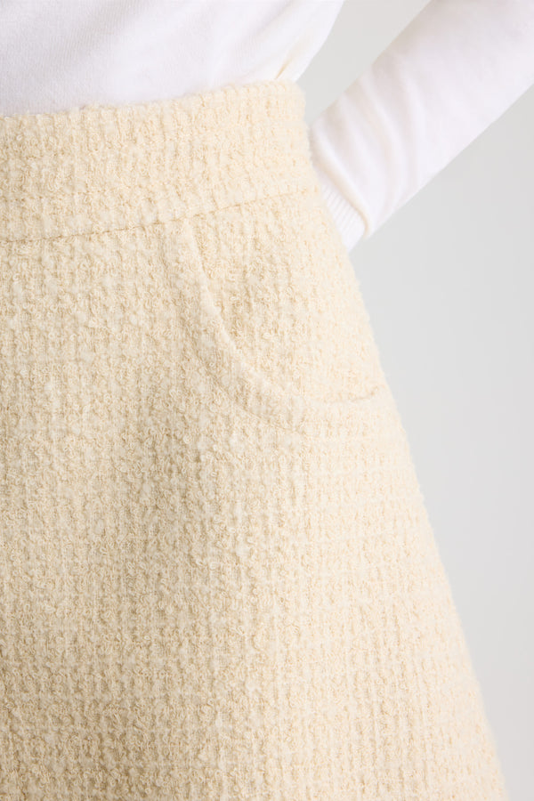 Patou - Asymmetric mini skirt in sustainable wool blend tweed - Snowberry White - Snowberry White sustainable wool blend tweed skirt. Short length. Mid waist. Asymmetric silhouette with pleating on one side. Zip fastening at the back. Single rounded pocket at the side. Lined.