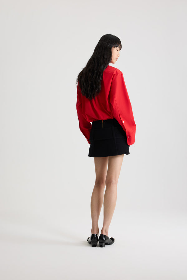Patou - Belted mini skirt in boiled wool - Black - Black boiled virgin wool skirt. Short length. Low waist. Zip fastening at the back. Wide fabric belt at the hips with fabric-covered buckle and gold-tone D-ring. Low pockets at the front. Lined.