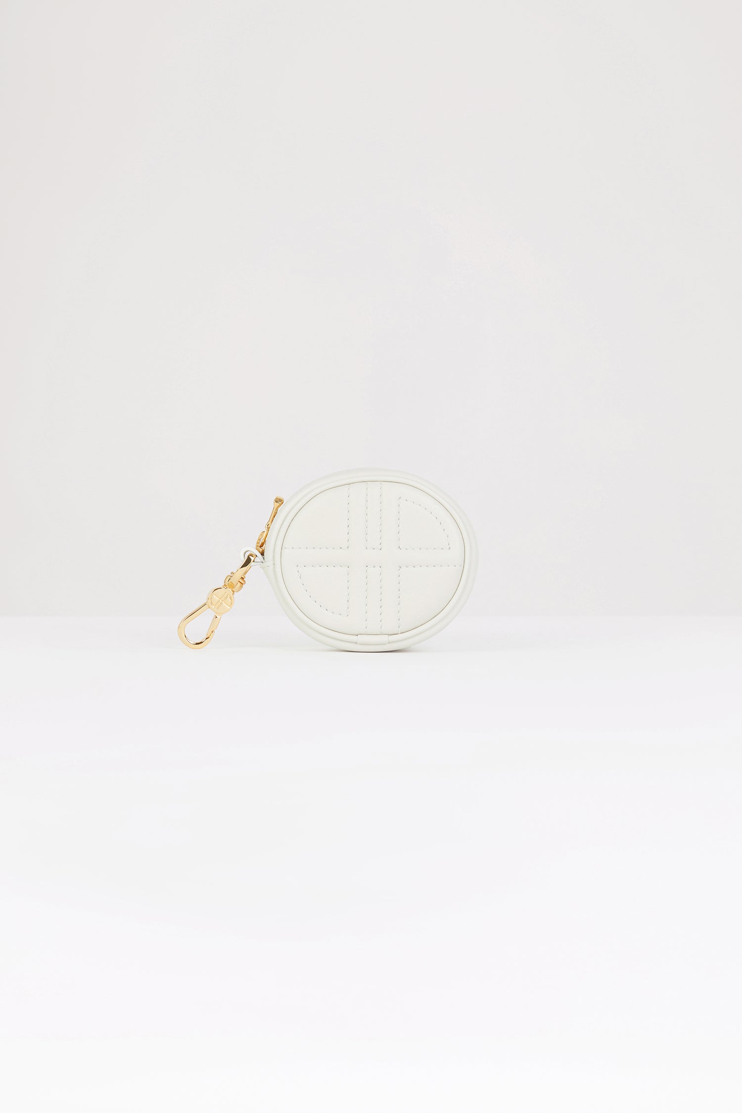Patou - Mini JP pouch in leather - Natural - The prettiest Patou charm.Natural white leather pouch. Crafted using unique materials sourced from unused high-quality leather hides. Can be used as a bag charm. Oval shape with a foam-padded 3D JP monogram at the front. Embossed Patou at the back. Zip fastening. Gold-tone hook. Designed to fit wireless earphones.