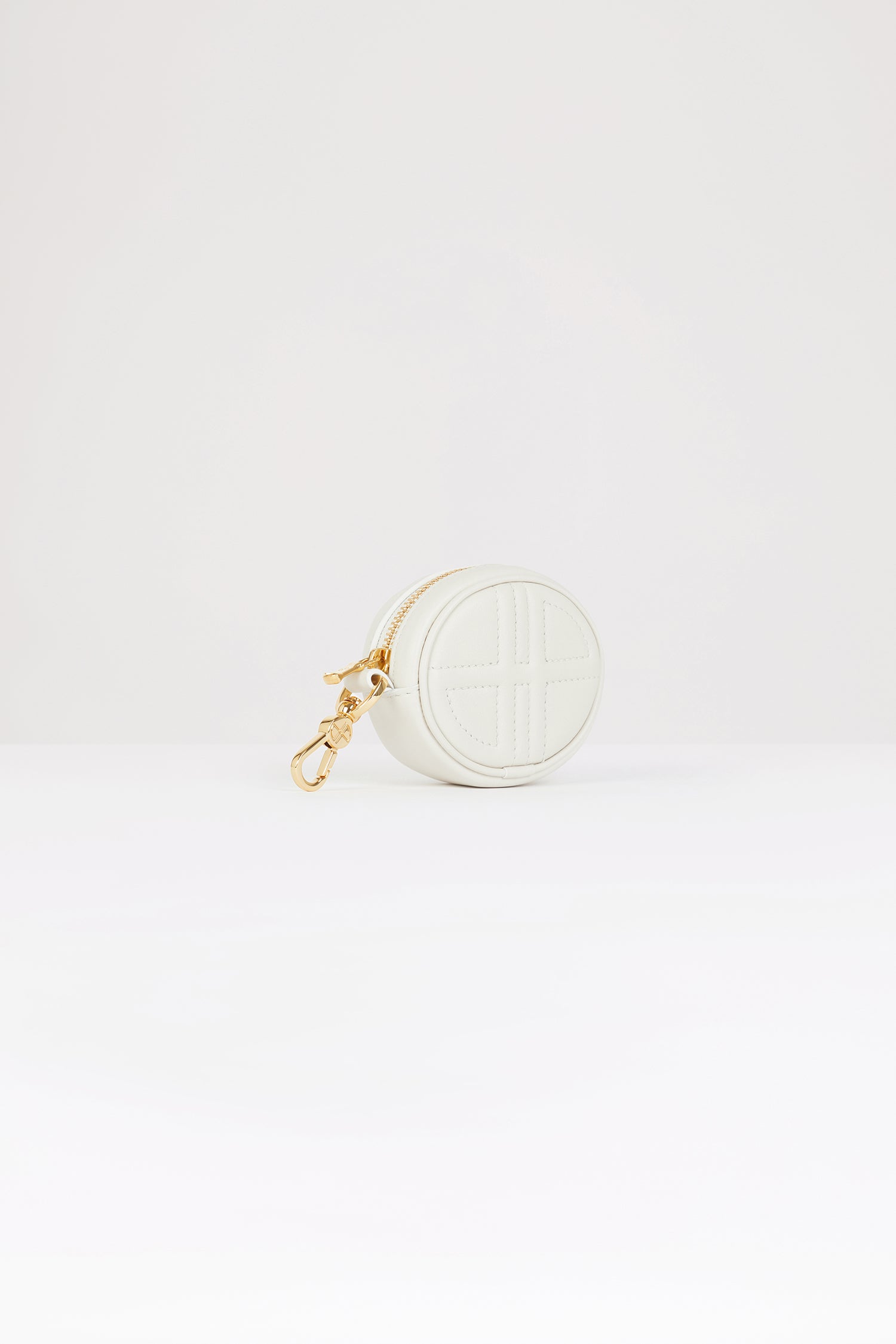 Patou - Mini JP pouch in leather - Natural - The prettiest Patou charm.Natural white leather pouch. Crafted using unique materials sourced from unused high-quality leather hides. Can be used as a bag charm. Oval shape with a foam-padded 3D JP monogram at the front. Embossed Patou at the back. Zip fastening. Gold-tone hook. Designed to fit wireless earphones.