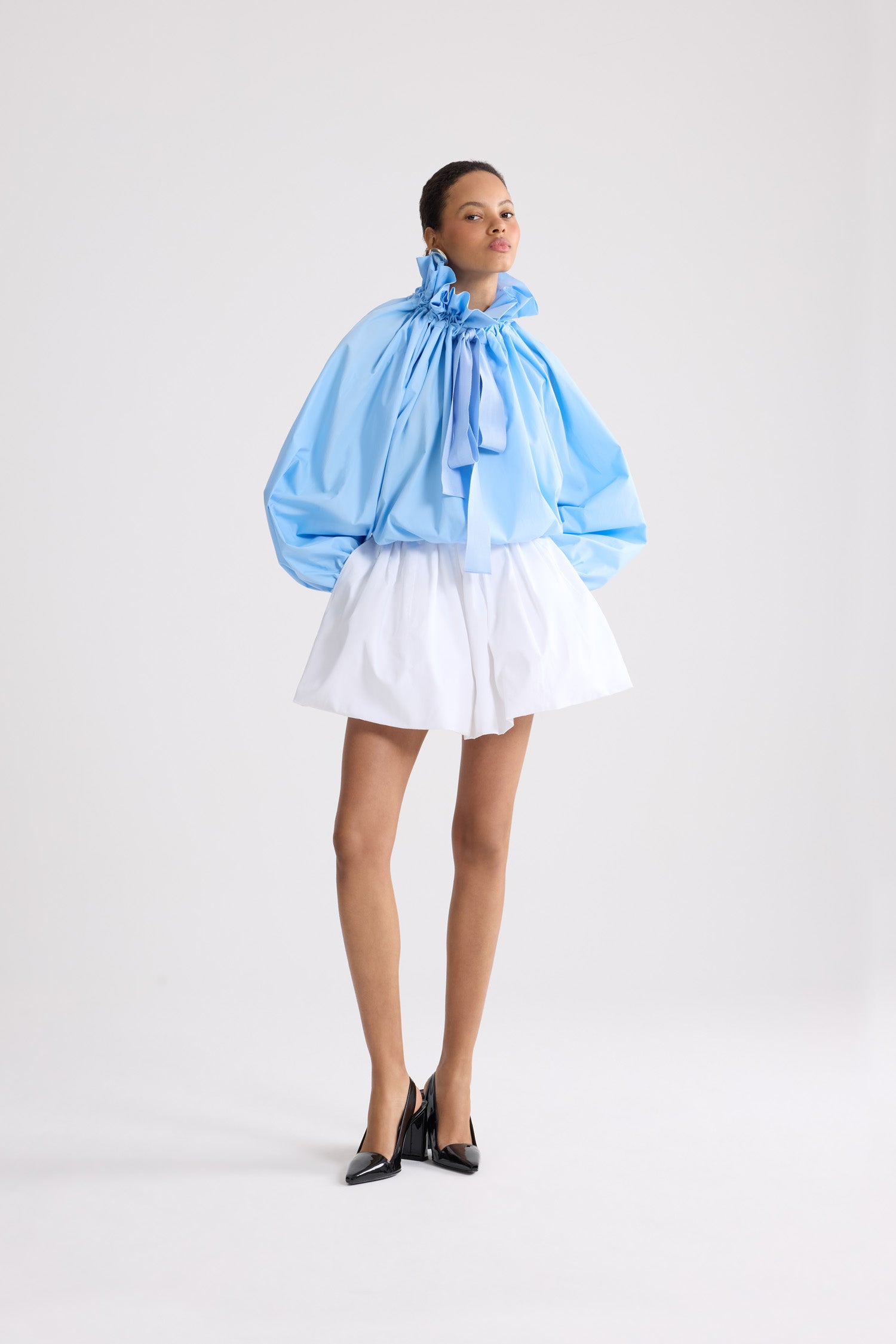 Patou - Iconic Organic Cotton Voluminous Top - Riviera Blue - Iconic voluminous top in light blue organic cotton. Very voluminous silhouette, can be worn tied at the neck or with bare shoulders. Drawstring collar with front gathering and long grosgrain ties. Batwing sleeves with elasticated cuffs. Elasticated waist.