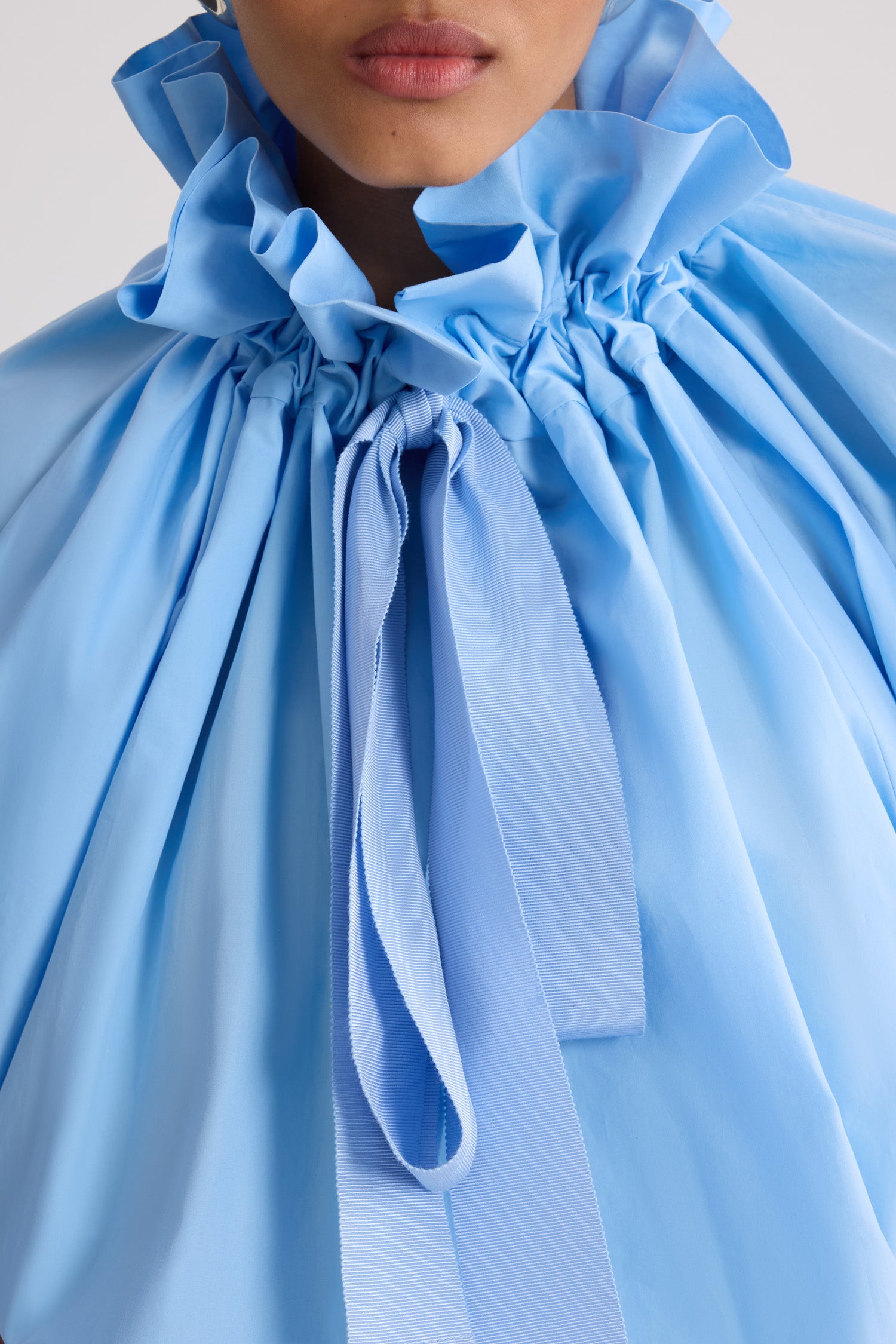 Patou - Iconic Organic Cotton Voluminous Top - Riviera Blue - Iconic voluminous top in light blue organic cotton. Very voluminous silhouette, can be worn tied at the neck or with bare shoulders. Drawstring collar with front gathering and long grosgrain ties. Batwing sleeves with elasticated cuffs. Elasticated waist.