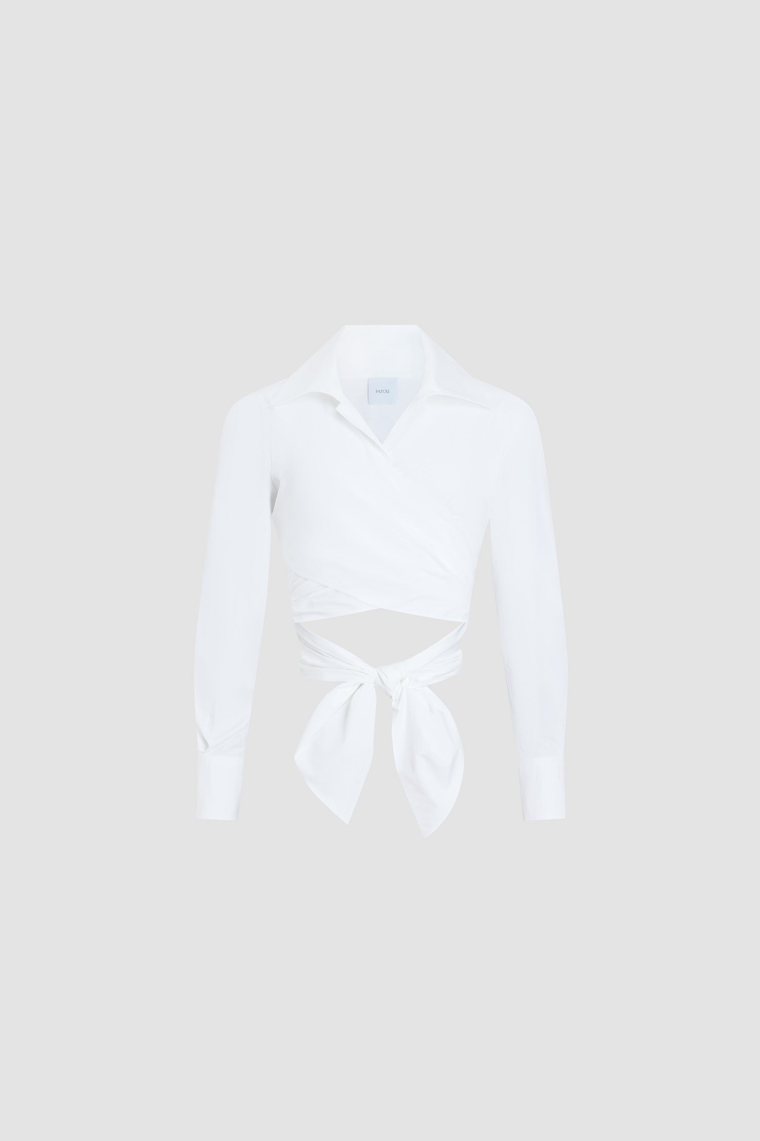 Patou - オーガニックコットン 長袖 ノットトップス - White - ホワイトカラーの長袖トップス。オーガニックコットン素材。Vネック。バックにノット付き。