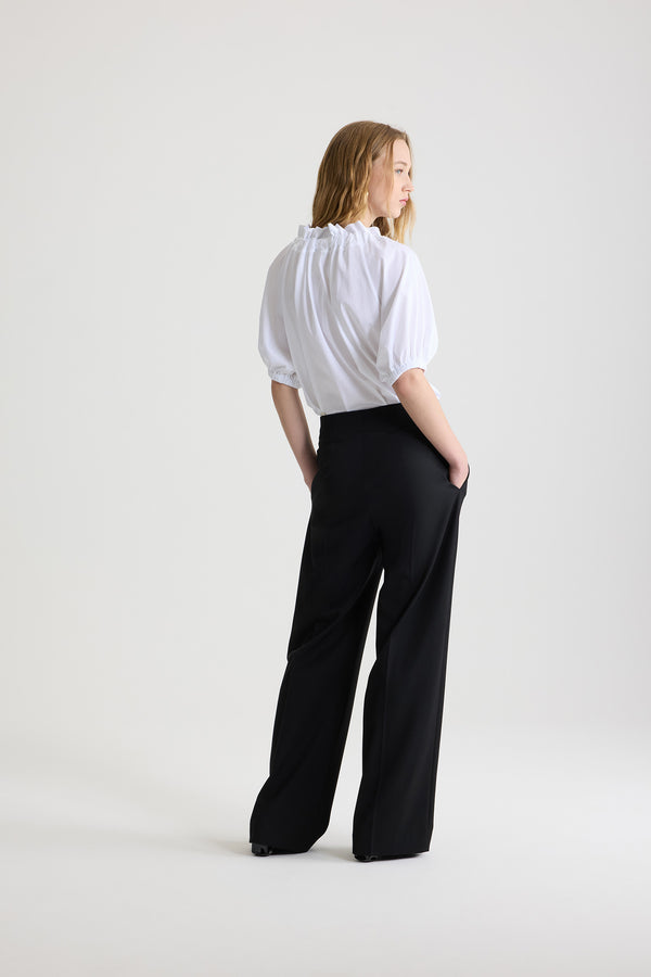 Patou - Iconic long trousers in virgin wool - Black - Black stretch virgin wool trousers. Iconic Patou silhouette. Straight fit. Fastens via a gold-coloured JP-engraved button and zip at the front. Belt loops, two pockets at the sides. Signature darts at the back.