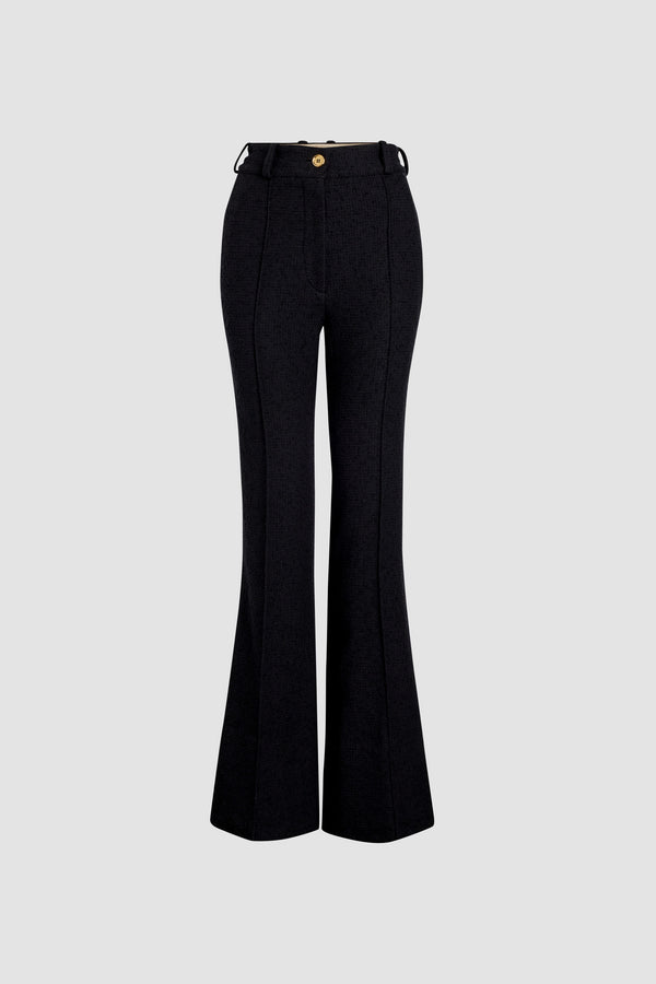 Patou - Pantalone flare in tweed di lana ecosostenibile e cotone bio - Black - Pantalone in tweed di lana ecosostenibile e cotone bio nero. Gamba svasata. Vita alta. Passanti per cintura. Chiusura con bottone oro inciso JP e zip sul davanti. Tasche ai lati. Pieghe sul davanti.Questo modello veste lungo.
