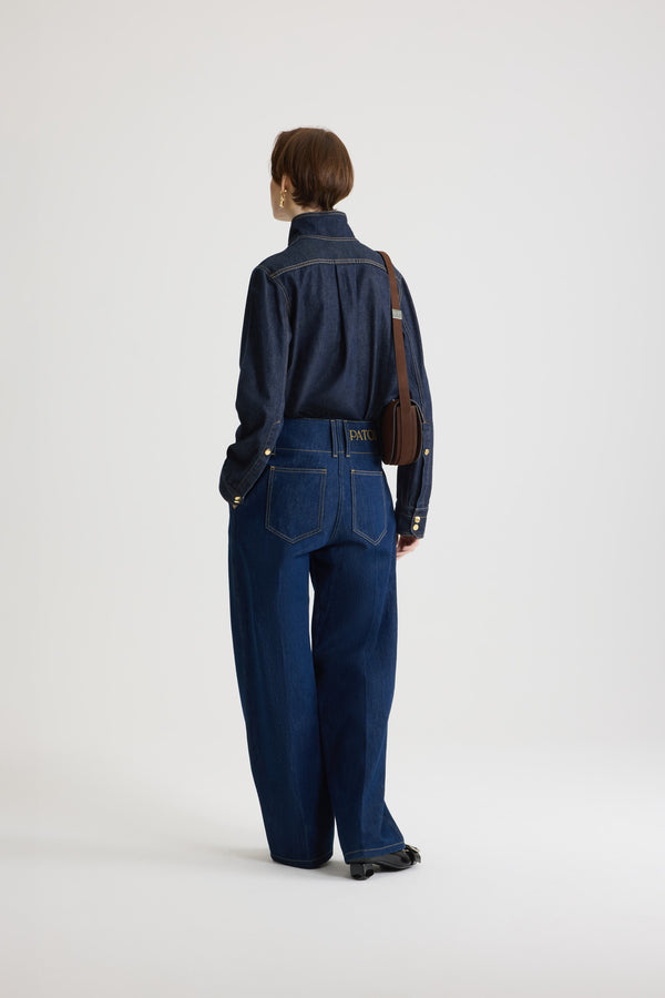 Patou - Wide waistband trousers in cotton denim - Rodeo Blue - Rodeo Blue cotton denim trousers. Mid to low waist. Straight leg. Belt loops. Fastens via a gold-tone Patou logo-engraved button and concealed zip at the front. Pockets at the sides. Pressed crease at the front.