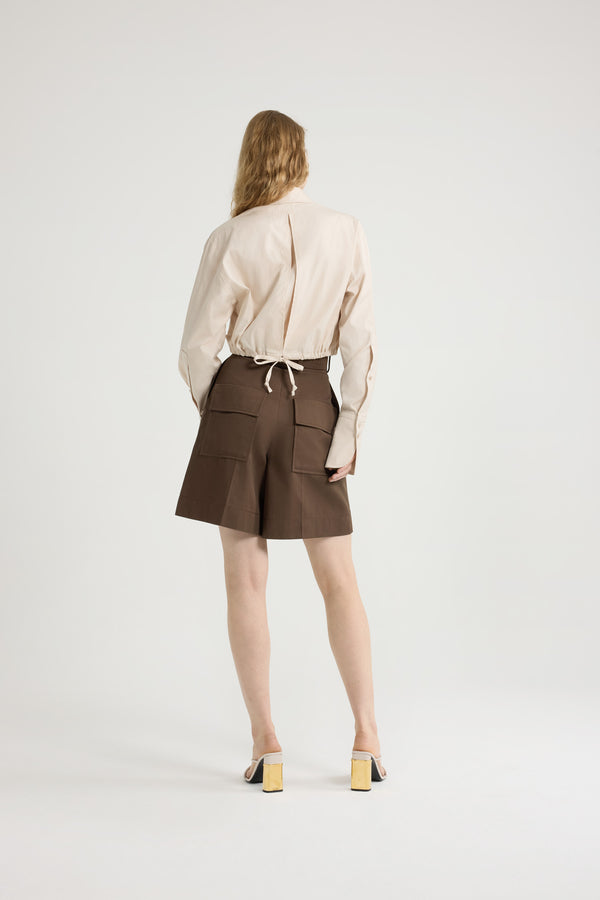 Patou - Bermudas in organic cotton gabardine - Java Brown - Java Brown organic cotton gabardine bermudas. High rise. Belt loops. Fastens via a gold-tone JP monogram-engraved button and concealed zip at the front. Pressed creases at the front. Patch pockets at the back. Embroidered Patou logo on the waistband.