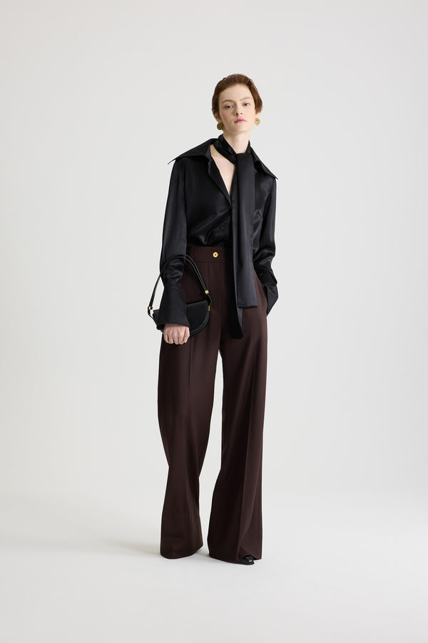 Patou - サステナブルテクニカルウール フレア テーラードパンツ - Smoked Ebony - スモークドエボニーのサステナブルなテクニカルウールツイルパンツ。長めのフレアレッグ。フロントにゴールドトーンのJPモノグラム刻印入りボタンと隠しファスナー。ベルトループ付き。サイドにポケット。前面と背面にステッチクリース。