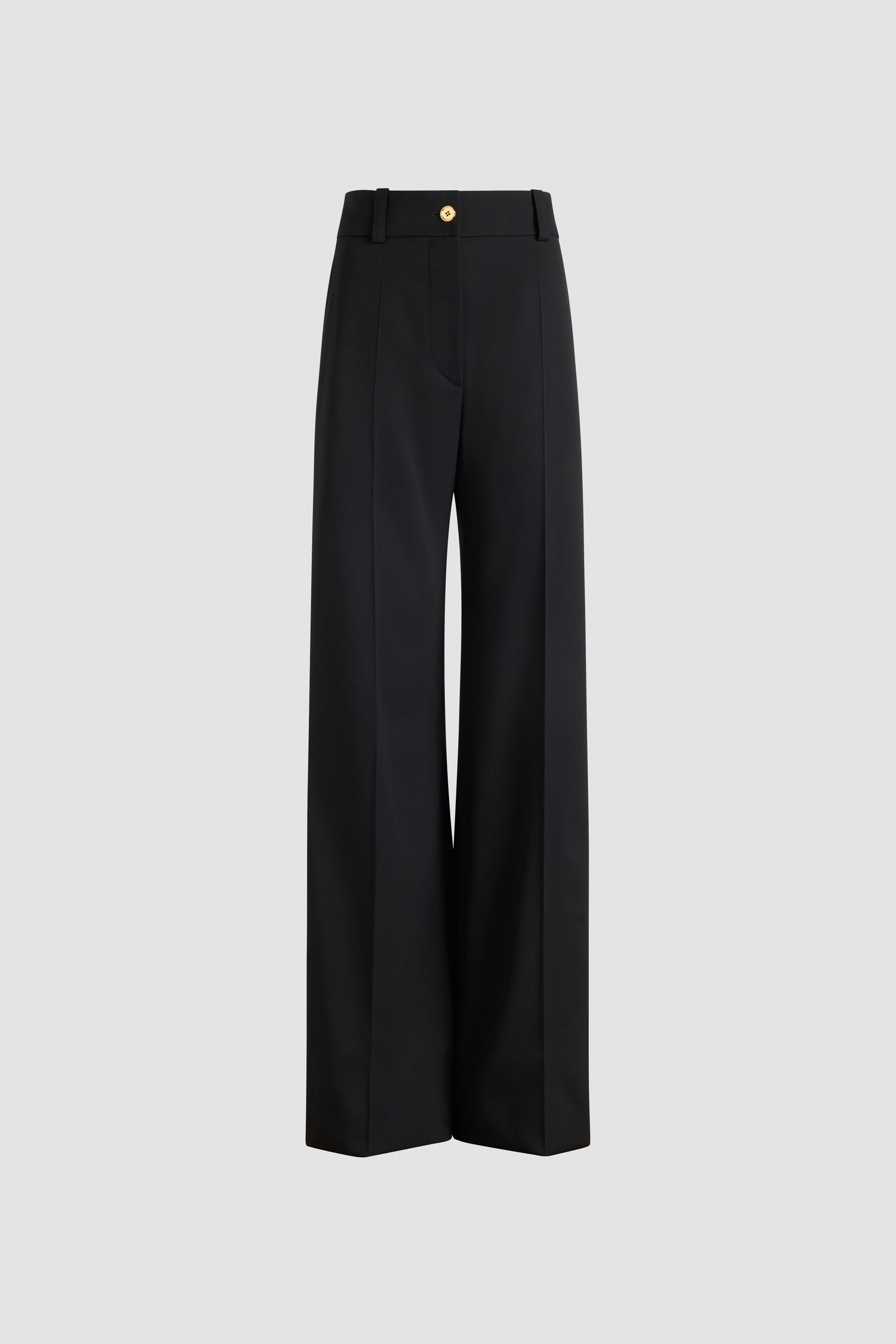 Patou - Flared tailored trousers in sustainable technical wool - Black - Black sustainable technical wool twill trousers. Long flared leg. Gold-tone JP monogram-engraved button and concealed zip at the front. Belt loops. Pockets at the sides. Stitched crease at the front and back.