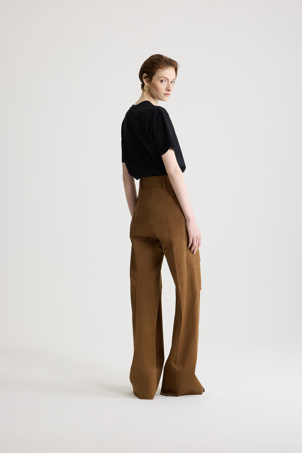 Patou - Flared cargo trousers in organic cotton gabardine - Nutmeg - Nutmeg light brown organic cotton gabardine trousers. Long flared leg. Gold-tone JP monogram-engraved button and concealed zip at the front. Belt loops. Pockets at the sides; cargo pockets on the legs with gold-tone JP monogram-engraved snap buttons. Stitched crease at the front and back.