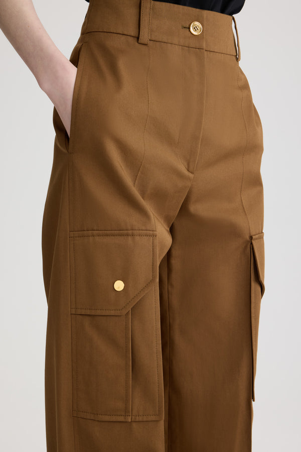 Patou - Flared cargo trousers in organic cotton gabardine - Nutmeg - Nutmeg light brown organic cotton gabardine trousers. Long flared leg. Gold-tone JP monogram-engraved button and concealed zip at the front. Belt loops. Pockets at the sides; cargo pockets on the legs with gold-tone JP monogram-engraved snap buttons. Stitched crease at the front and back.