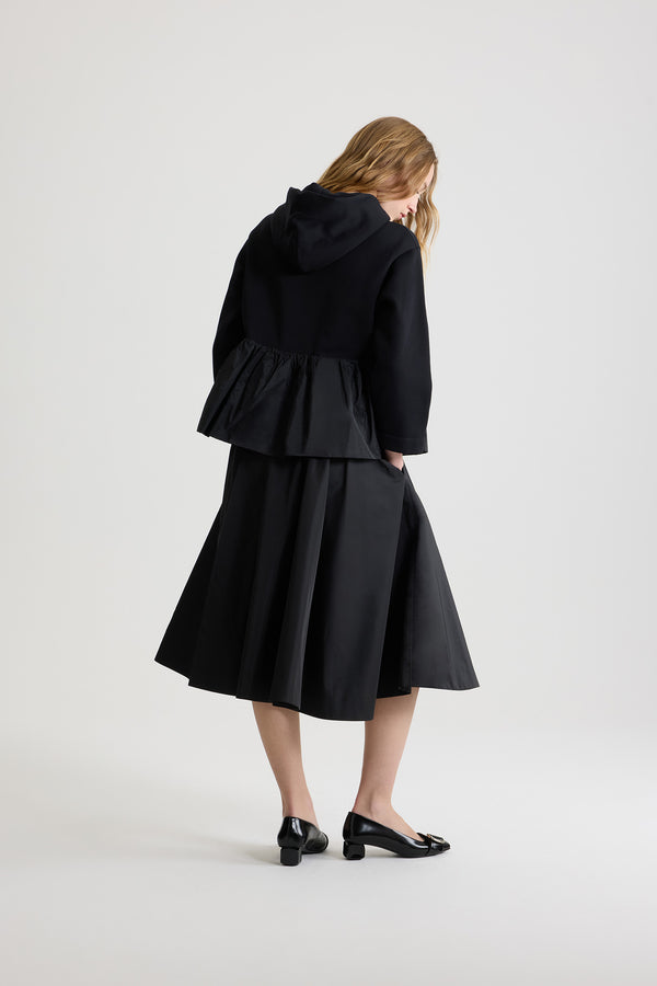 Patou - Asymmetric bermuda shorts in recycled faille - Black - Black recycled polyester faille shorts. Knee length. Mid waist. Asymmetric silhouette with pleating on one side. Elasticated waist. Pressed crease at the front and back.