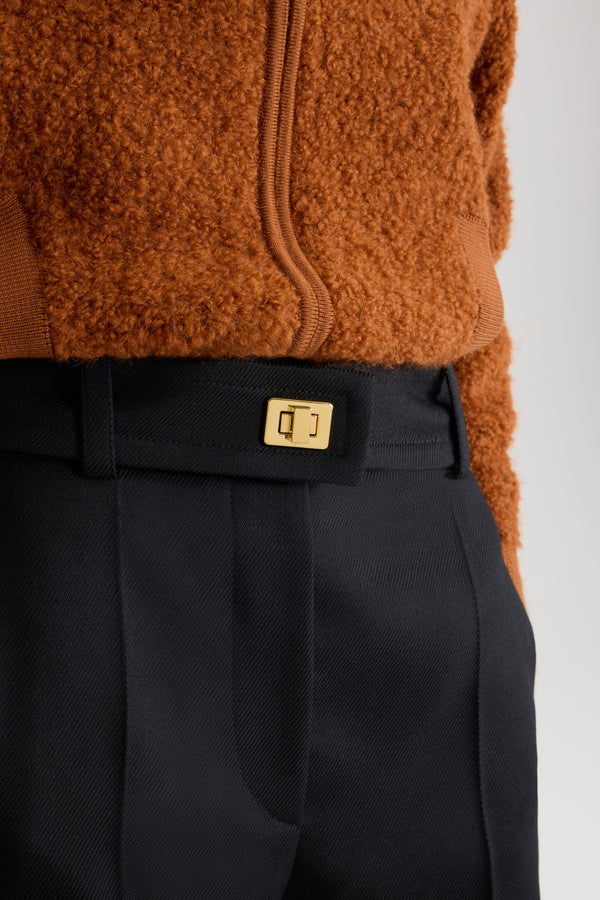 Patou - Lock flared tailored trousers in wool - Black - Black virgin wool trousers. Long flared leg. Gold-tone lock fastening and concealed zip at the front. Belt loops. Pockets at the sides. Stitched crease at the front and back.