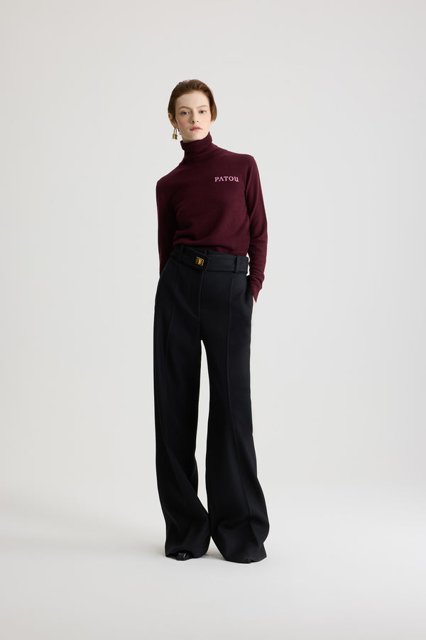 Patou - Lock flared tailored trousers in wool - Black - Black virgin wool trousers. Long flared leg. Gold-tone lock fastening and concealed zip at the front. Belt loops. Pockets at the sides. Stitched crease at the front and back.
