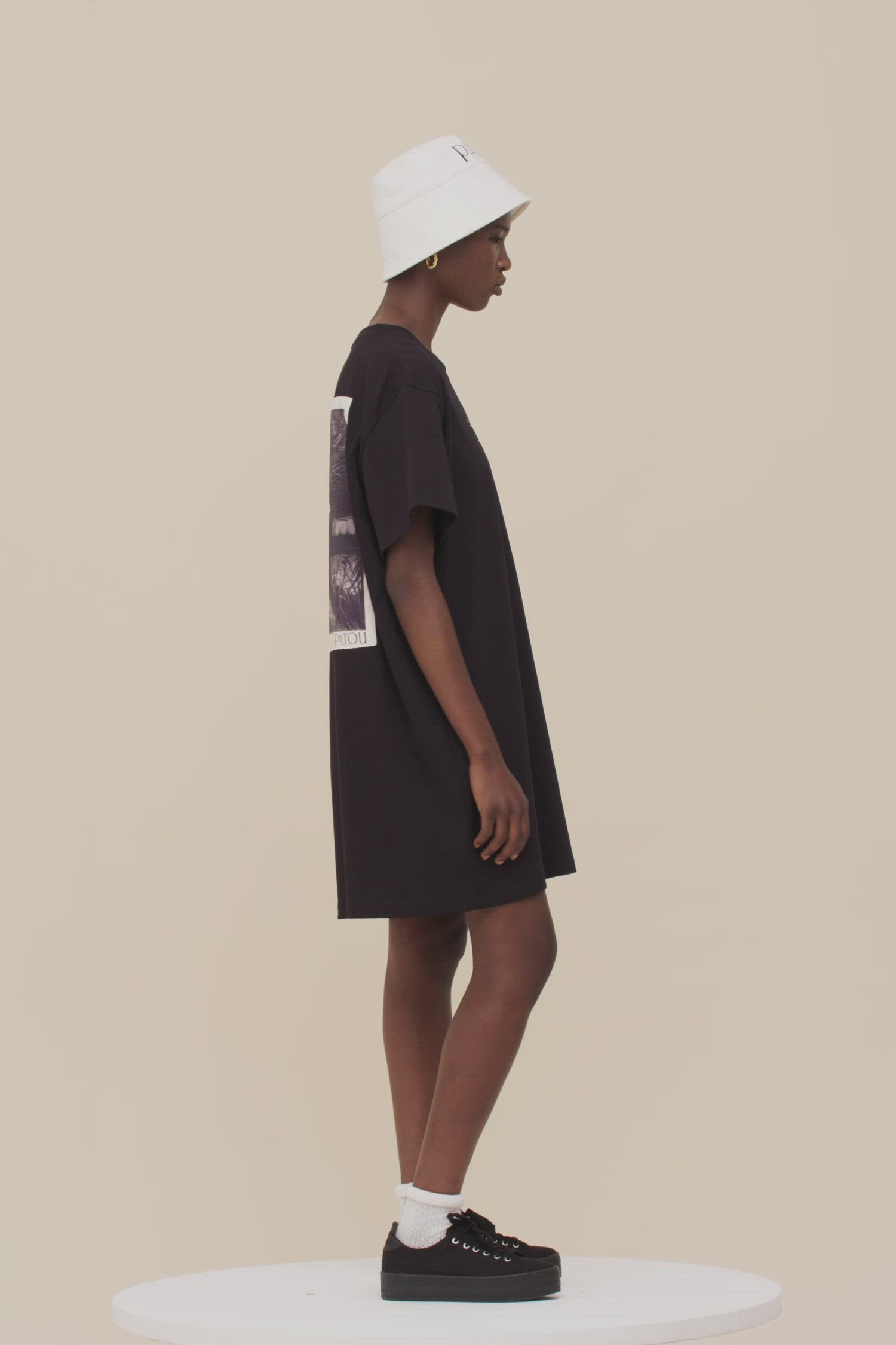 Patou - T-Shirt-Kleid „Gestiefelter Kater“ aus Bio-Baumwolle - Black - Wenn lässig und verspielt aufeinander treffen.   T-Shirt-Kleid aus Bio-Baumwolle in Schwarz. Rundhalsausschnitt. Weiße Buchstaben auf der Vorderseite. Klassische „Gestiefelter Kater“-Illustration von Gustave Doré und aufgedrucktes Patou-Buchstabenlogo auf der Rückseite.