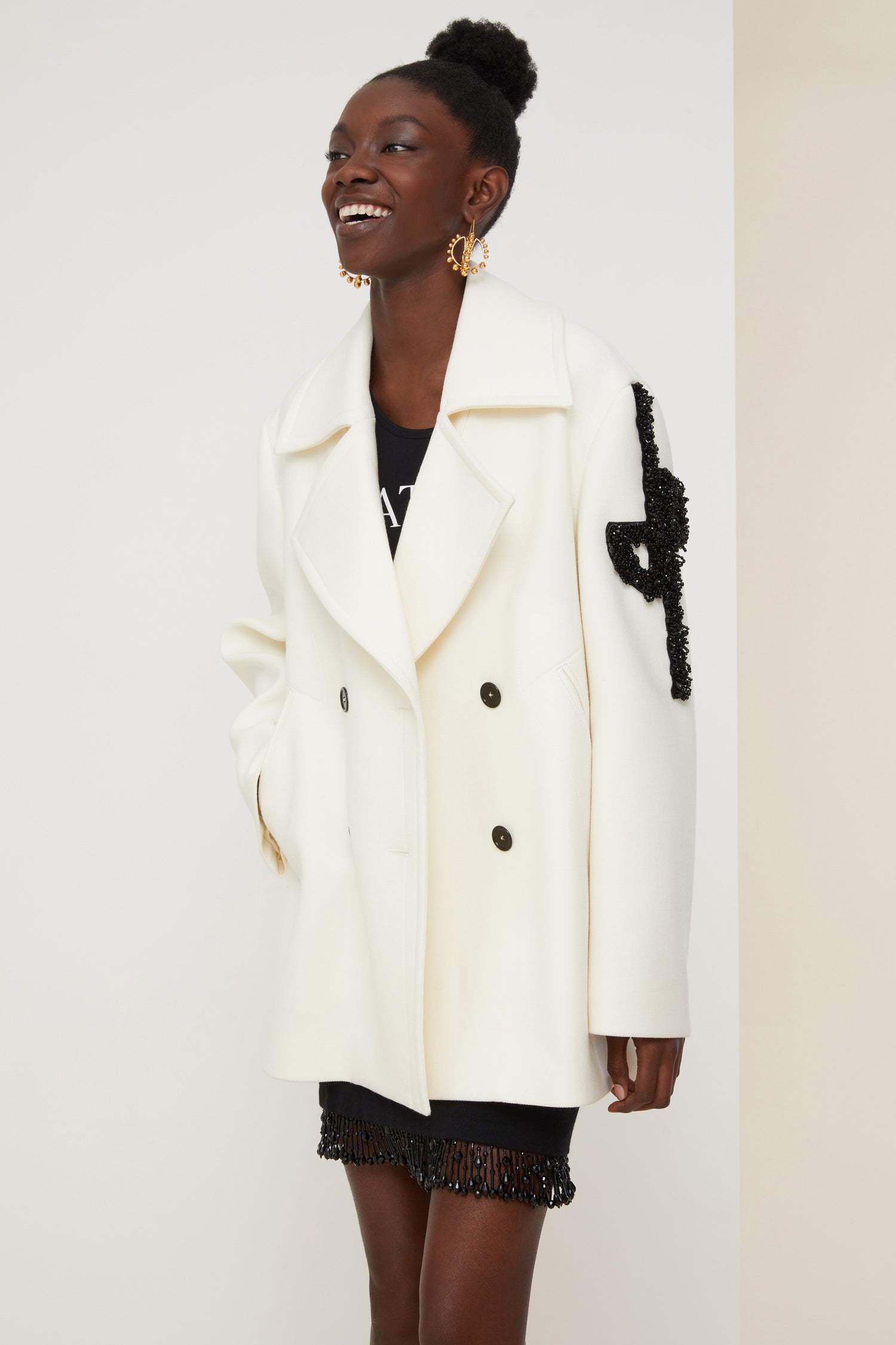 Patou - Jewelled logo peacoat - Pearl - The logo, a signature and an embellishment.Pearl white virgin wool peacoat. Double-breasted style with exaggerated lapels. JP logo in black pearls on the left sleeve. Contrasting black buttons. Welt pockets. Fully lined.