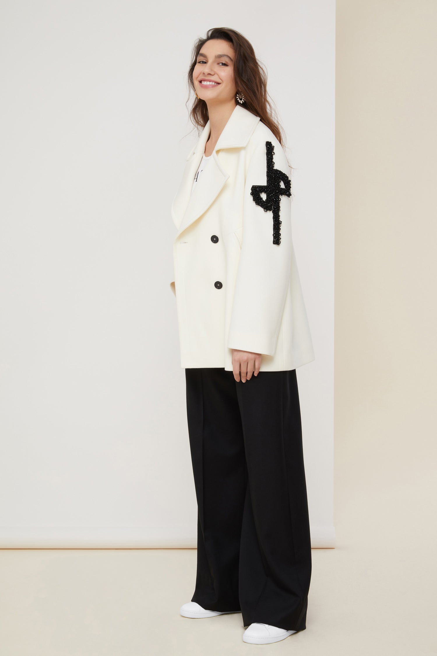 Patou - Jewelled logo peacoat - Pearl - The logo, a signature and an embellishment.Pearl white virgin wool peacoat. Double-breasted style with exaggerated lapels. JP logo in black pearls on the left sleeve. Contrasting black buttons. Welt pockets. Fully lined.